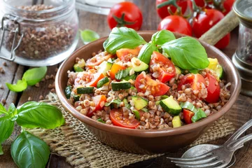 Fototapeten Delicious vegetarian buckwheat salad with zucchini, cherry tomatoes and fresh basil. Healthy eating and weight loss recipe © kuvona