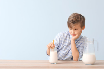 Little boy with dairy allergy on color background