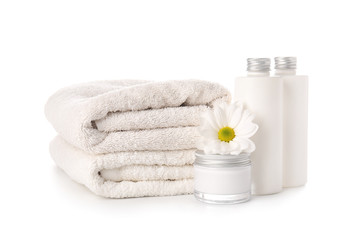 Obraz na płótnie Canvas Shampoo, cream and towels on white background