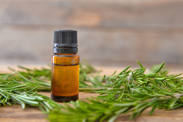 Bottle of rosemary essential oil on table