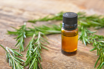 Bottle of rosemary essential oil on table
