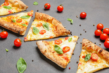 Delicious cut pizza Margherita on grey background
