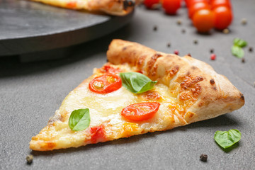 Slice of delicious pizza Margherita on grey background