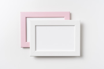 top view of two pink and white wood photo frame