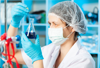 Scientist holds and examine samples in a laboratory