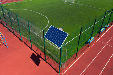 Solar panel on the rack. The panel is located on the sports field. Stadium lighting. Autonomous...