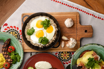 Fried egg with green spinach in pan, healthy breakfast. Healthy food.