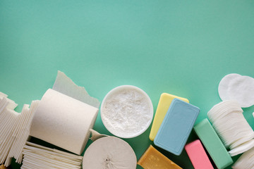 Set of various hygiene products on a mint background