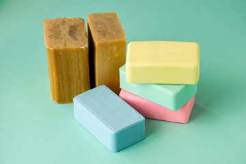 Heap of various soap on a colored background