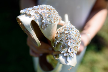 wedding shoes in brides hands