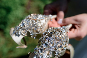 wedding shoes in brides hands