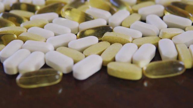 Various pills and tablets, close up dolly shot with selective focus