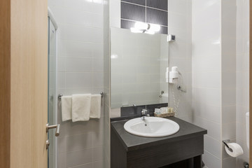 Fototapeta na wymiar Interior of a hotel bathroom with glass shower cabin