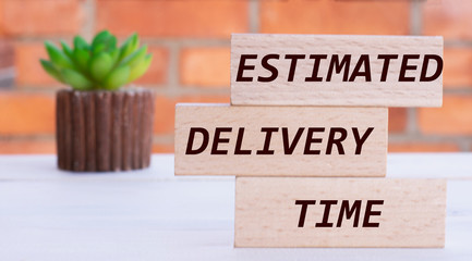 ESTIMATED, DELIVERY, TIME the words on cubes against the background of a brick wall with a cactus.