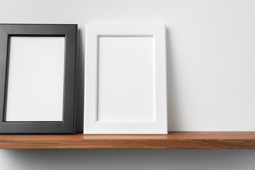 vertical wood photo on bookshelf and wall