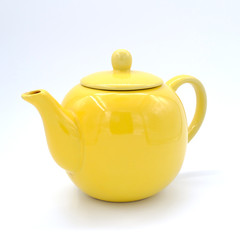 Yellow teapot isolated on white background