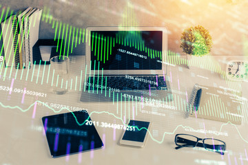 Financial graph colorful drawing and table with computer on background. Double exposure. Concept of international markets.