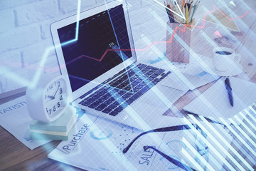 Financial market graph hologram and personal computer on background. Multi exposure. Concept of forex.
