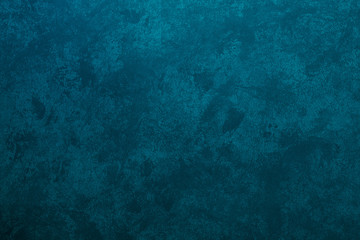 Texture of stucco painted in a heterogeneous turquoise color