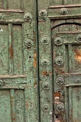 Cusco Peru. Antique green door. Worn out. 