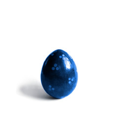 One easter blue egg on a white .