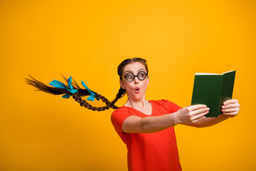 No way. Photo of funny student lady open mouth clever person hairdo flight read exciting book not believe eyes intrigue wear casual red t-shirt isolated vibrant yellow color background