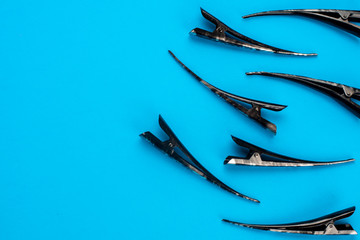 Hair clips on a blue background , lots of black and gray there are places for writing, copy space
