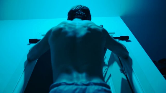 Man at home doing pull-up fitness training 4K