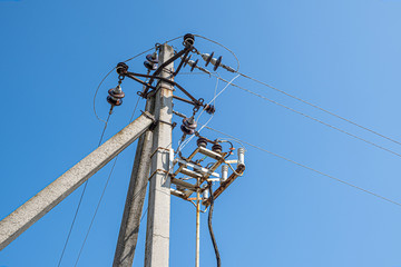 Old electric pole against the sky