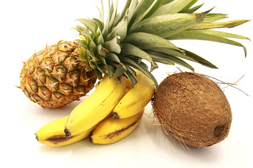 Ripe pineapple, bananas and coconut close-up isolated on a white background © revo9