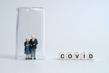Pandemic corona virus conceptual miniature people photography – word beads alphabet isolation / quarantine concept with doctor and old / middle-aged figure on tube - obrazy, fototapety, plakaty
