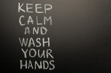 Chalk inscription on the blackboard - keep calm and wash your hands. Coronavirus and danger of getting sick. With space for inscription