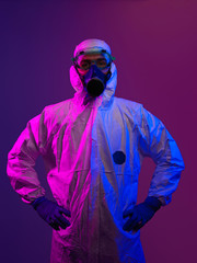 Doctor wearing protective biological suit and mask due to coronavirus