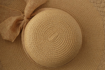 Fototapeta na wymiar women's summer hat with wide brim, straw (golden) color, with a bow
