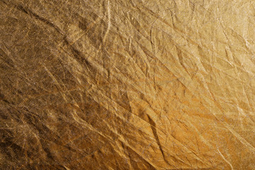 golden foil or fabric, texture suitable for gold leaf, photo reflector or foil