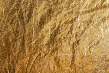 golden foil or fabric, texture suitable for gold leaf, photo reflector or foil