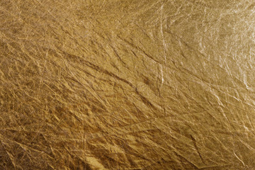 golden foil or fabric, texture suitable for gold leaf, photo reflector or foil