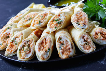 Thin crepes with cream cheese and shredded salmon