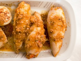 Delicious homemade stuffed squid with tomato and vegetable sauce