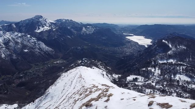 Group of hikers on snowy mountain ridge, Grigna, Lecco, Italy