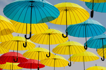 Fototapeta na wymiar Colorful umbrellas background. Colorful umbrellas in the sky. Street decoration 