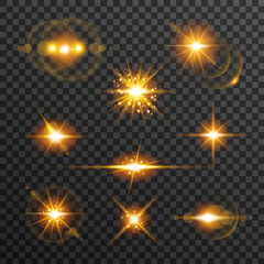 Obraz premium Light flare set in golden color isolated on transparent background. Sun rays, glowing stars, sparkles with glow effect, vector illustration