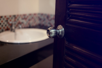 Toilet door open with sink