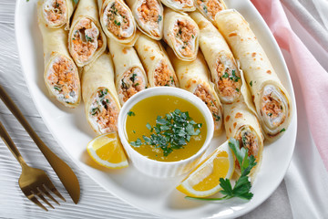Pancakes stuffed with soft cream cheese and salmon