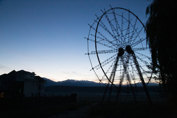 Silhouette of abandoned ferris wheel