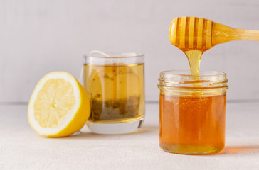 Honey jar, pot, cup of tea, lemon and wooden spoon. Health. immunity.