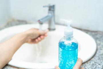 Asian washing hand by press blue alcohol sanitizer gel for protect infection and kill Novel Coronavirus (2019-nCoV) Covid-19 virus, bacteria and germs..