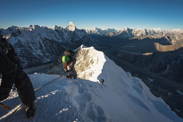 Climber climbing up to summit of Island peak in Everest region, Himalaya range in Nepal