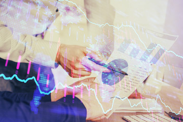 Financial trading graph double exposure with man desktop background.