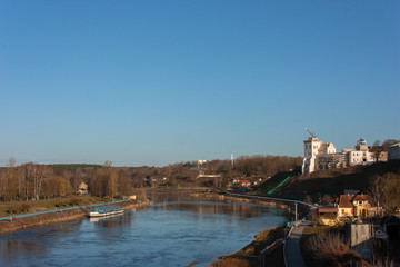 Sights and views of Grodno. Belarus. Neman river. On the high bank of the river is the restored Old Castle building and other buildings along the river.